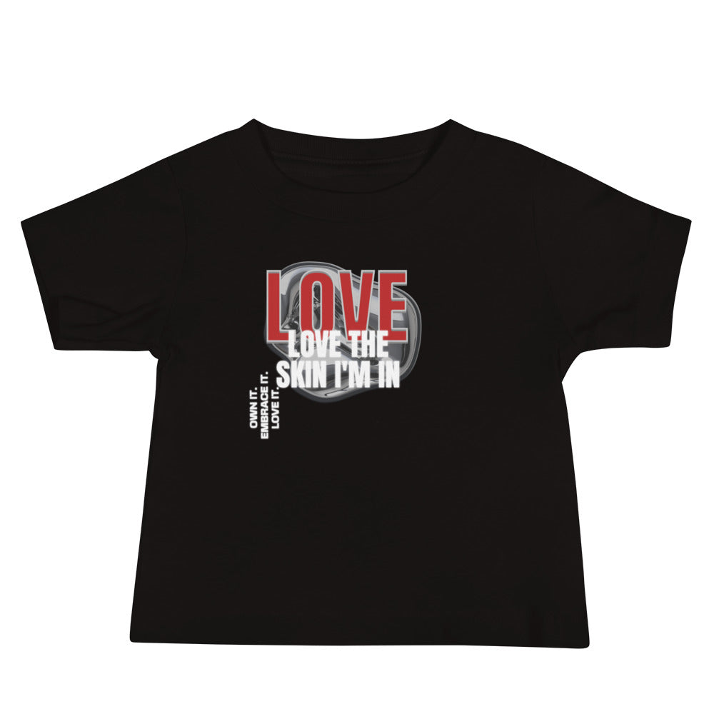 Black baby t-shirt with bold red “LOVE” and white “Love the Skin I’m In” text with smaller caption.