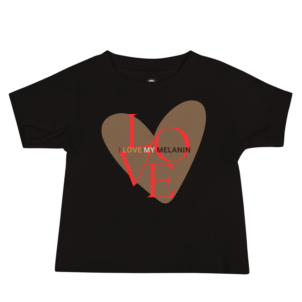 Black baby t-shirt with large brown heart and “I Love My Melanin” in bold red and brown shades, celebrating pride and confidence.