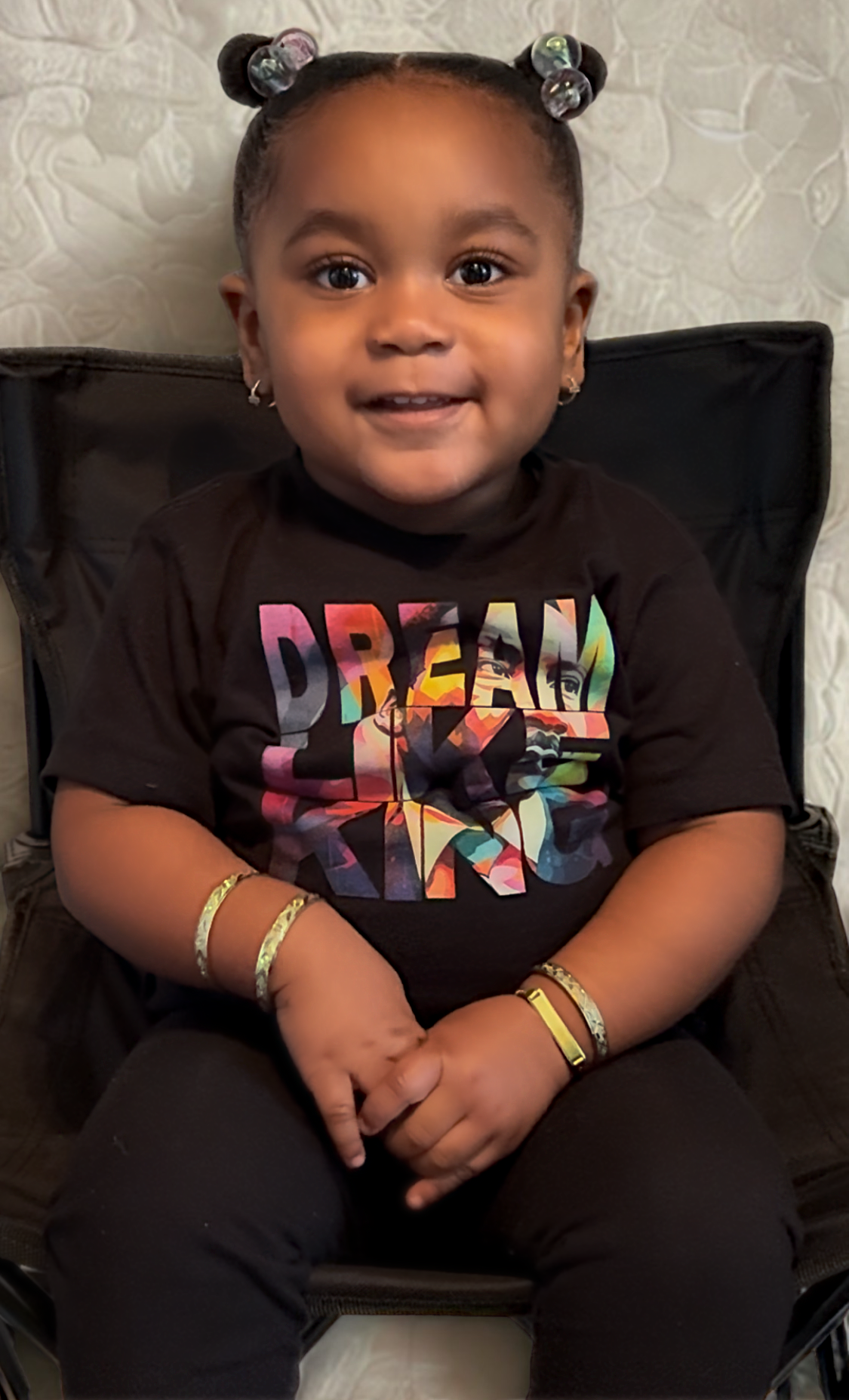 Toddler girl wearing “Dream Like King” t-shirt celebrating Black history, confidence, and pride.
