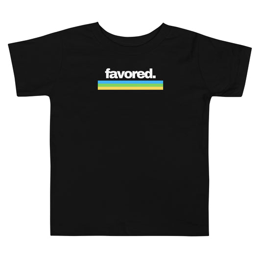 Toddler t-shirt in black with “Favored” in white 80’s retro font and blue, green, yellow stripes, inspiring confidence, joy, and faith.