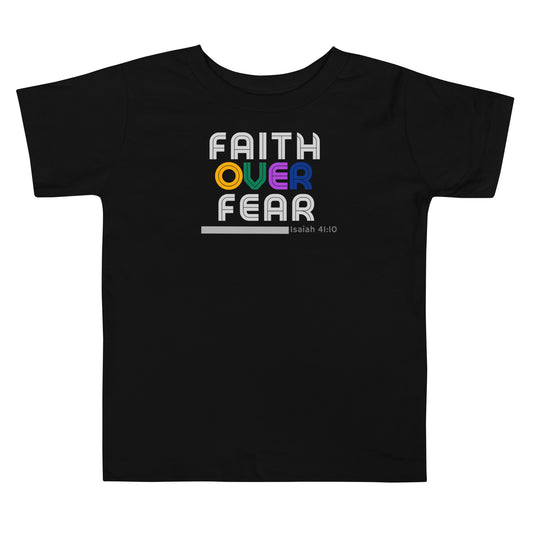 Toddler t-shirt in black with “Faith Over Fear” retro lettering: gray “Faith” top, colorful “over” middle, gray “Fear” bottom, promoting courage, confidence, and faith.